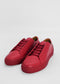 A pair of ML0060 Red Leather sneakers, ethically made to order with matching red laces and soles, displayed on a plain white background.