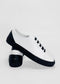 A pair of ML0066 White W/ Black sneakers with black soles and laces, displayed on a white background. Handcrafted in Portugal, the heel of one shoe has the text "T-01," showcasing their premium Italian leathers.
