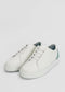 A pair of ML0079 White Floater W/ Green with white laces. The heel area features a light green accent, adding a subtle pop of color. Ethically made and handcrafted in Portugal using premium Italian leathers, these shoes boast a plain, minimalist design perfect for any occasion.