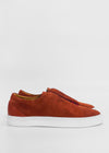 Side view of a pair of ML0073 Caramel Suede slip-on sneakers, handcrafted with premium Italian leather and white rubber soles, against a plain white background.
