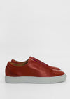 Pair of ML0077 Red W/ Grey slip-on, handcrafted sneakers with white soles, shown in a side view against a plain white background.