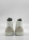 The MH0115 White Leather W/ Grey sneakers, featuring gray suede accents on the heels and handcrafted in Portugal, are photographed against a plain gray background with their backs facing the camera.