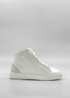 The MH0118 White Leather W/ Bone high-top sneaker, showcasing a clean, minimalist design, is displayed against a plain, light background. Handcrafted in Portugal from premium Italian leathers, it features a distinctive suede patch on the heel.