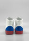 Rear view of MH0119 White W/ Electric Blue high-top sneakers featuring blue heel caps and red soles, meticulously handcrafted in Portugal using premium Italian leathers, set against a gray background.