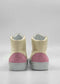 Rear view of a pair of MH0123 Beige Leather W/ Pink high-top sneakers, featuring cream-colored premium Italian leathers and pink suede accents on the heels, handcrafted in Portugal and shown against a plain white background.