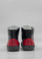 Back view of MH0124 Black Leather W/ Red high-top sneakers, handcrafted from premium Italian leathers, on a gray background.