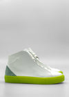 The MH0125 White Leather W/ Pastel Green high-top sneakers, featuring bright green soles and a green heel accent, handcrafted in Portugal, photographed against a plain gray background.