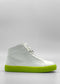 The MH0128 White Leather W/ Yellow high-top sneaker, handcrafted in Portugal and featuring a bright neon green sole, set against a plain grey background.