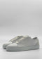 A pair of ML0094 Grey Floater W/ Plaster, handcrafted in Portugal with premium Italian leathers and white laces, is set against a plain light grey background.