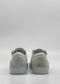 A pair of ML0094 Grey Floater W/ Plaster sneakers, handcrafted in Portugal using premium Italian leathers, viewed from the back against a plain white background.