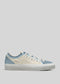 The V10 Antique-White & Sky sneaker is a low-top with a premium blue and white canvas upper, featuring white laces and a rubber sole, elegantly displayed against a plain background.