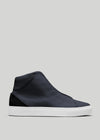 The V46 Blue Floater W/ White is a high-top, navy-blue leather sneaker with a minimalist design and a white sole, handcrafted in Portugal from premium Italian leathers. It's elegantly displayed on a light gray background.