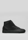 The V47 Black Leather, a black high-top sneaker, is crafted from premium Italian leather featuring a smooth upper and textured sole. Handcrafted in Portugal and ethically made to order, these sneakers enhance elegance and sustainability with their minimalistic design.