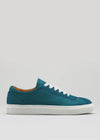 The V8 Petrol Blue low-top sneaker in teal, featuring white laces and a white sole, is handcrafted in Portugal and showcased against a plain background.