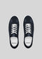 The V5 Deep Blue sneakers are handcrafted in Portugal from premium Italian leathers, featuring a black low-top design with white laces, showcased from above against a gray background.