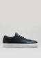 The V5 Deep Blue is a handcrafted low-top sneaker made in Portugal from premium Italian leathers, showcasing a navy blue design with white laces and a white sole, captured from the side against a plain background.