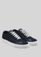 The V5 Deep Blue sneakers are low-top, handcrafted in Portugal from premium Italian leathers, and feature white soles and laces on a light gray background.