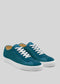 Introducing the V8 Petrol Blue sneakers: this handcrafted pair from Portugal showcases a striking teal color with premium Italian leathers, complemented by white laces and soles set against a gray backdrop.