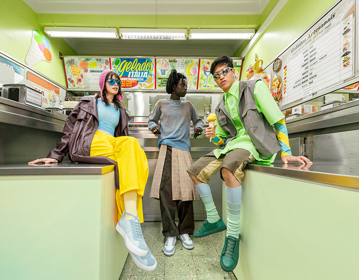 Three different people with three different styles of sneakers in three different colors.