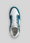 A single V9 Petrol Blue w/White is shown from above with a white and teal design, white laces, and the brand name "DEVERGE" visible inside. These retro-future sneakers are handcrafted in Portugal using premium Italian leathers.