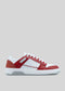 The M0016 by Elton is a red and white athletic sneaker, handcrafted in Portugal from premium Italian leathers, featuring perforated side paneling, white laces, and a thick rubber sole set against a light gray background.