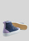 Introducing the TH0019 by Linda: a pair of high-top sneakers crafted with navy blue and lavender canvas material, featuring white laces and durable white rubber soles. These handcrafted shoes from Portugal are displayed with one shoe standing upright and the other lying on its side to showcase the intricate sole pattern.