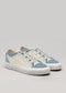 A pair of V10 Antique-White & Sky low-top customizable classic white sneakers featuring light blue accents with cream-colored sections and white laces on a light grey background.